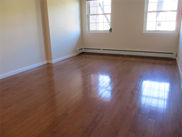 unfurnished room with baseboards, baseboard heating, and dark wood finished floors