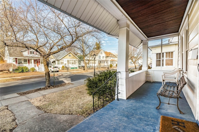 view of patio with covered porch and a residential view