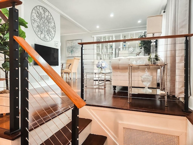 stairs with recessed lighting and crown molding