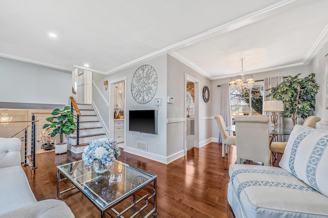 living room with stairway, wood finished floors, visible vents, ornamental molding, and a notable chandelier