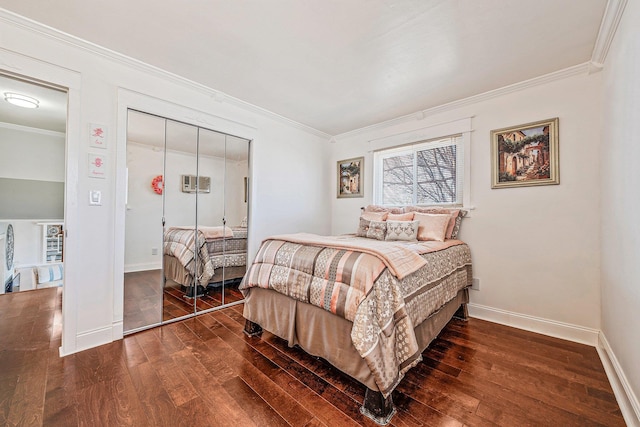 bedroom with a closet, crown molding, baseboards, and hardwood / wood-style floors