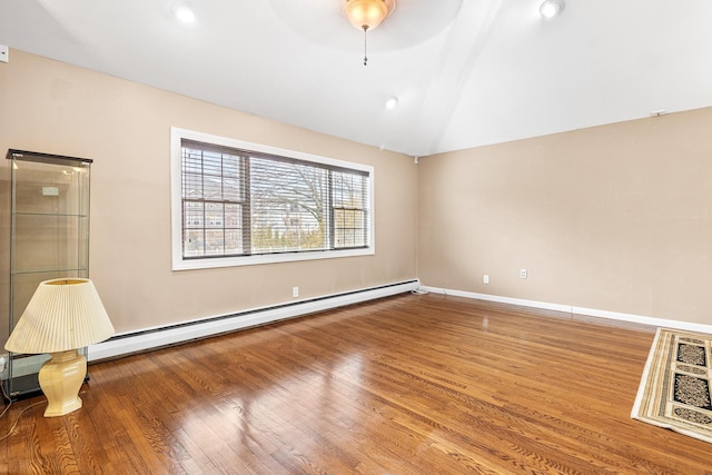 spare room with wood finished floors, baseboards, recessed lighting, vaulted ceiling, and baseboard heating