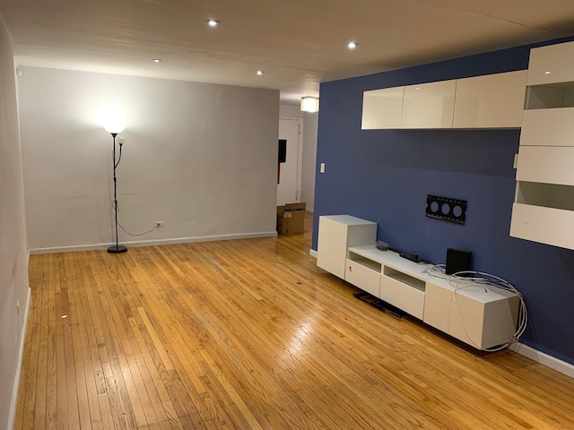 unfurnished living room featuring recessed lighting, baseboards, and light wood-style floors