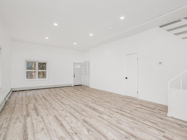 spare room featuring recessed lighting, light wood-type flooring, and a baseboard radiator