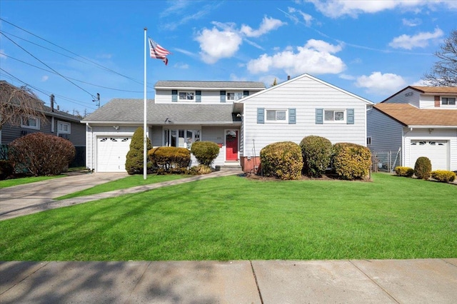 split level home with a front lawn, an attached garage, and driveway