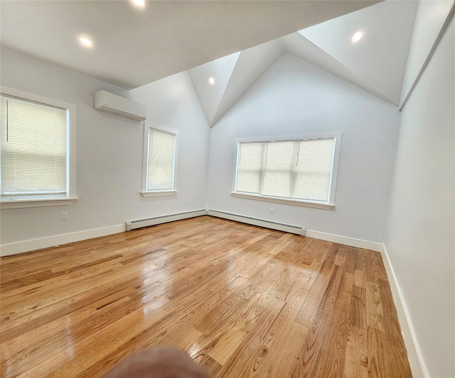 empty room with wood finished floors, baseboards, a baseboard radiator, lofted ceiling, and an AC wall unit