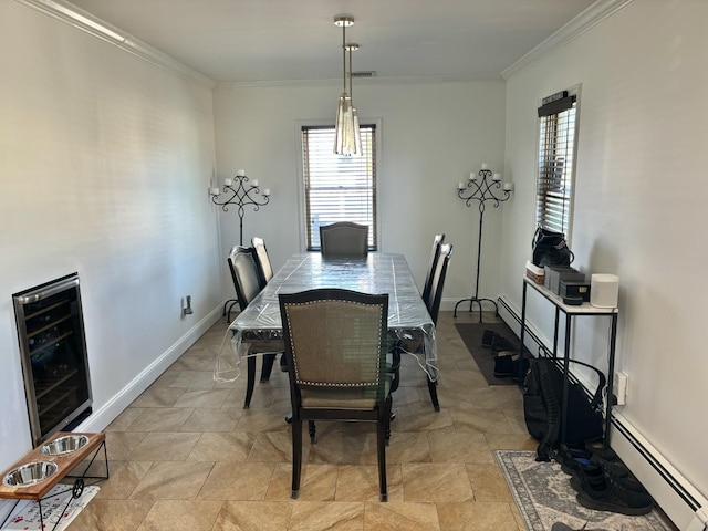 dining room featuring a baseboard heating unit, plenty of natural light, beverage cooler, and crown molding