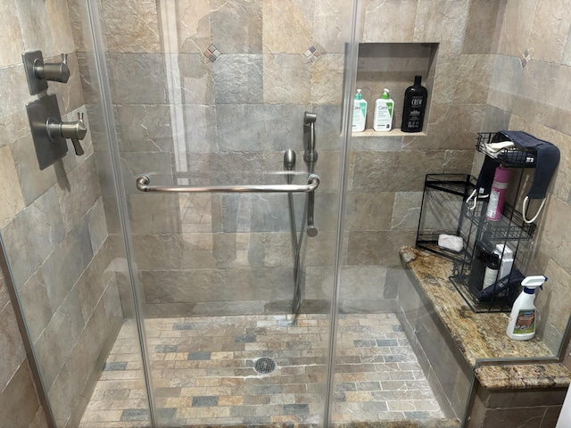 bathroom featuring a shower stall