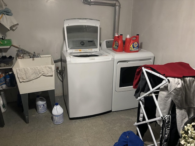 laundry area with a sink, laundry area, and washing machine and clothes dryer