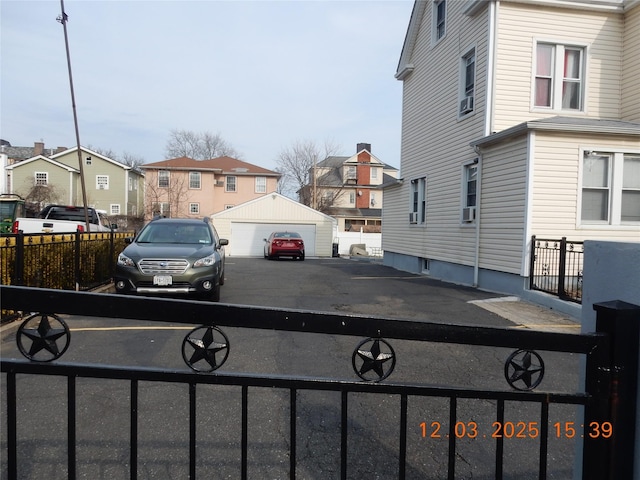 exterior space featuring an outbuilding, fence, and a residential view