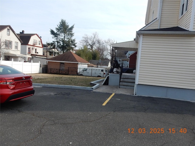 exterior space featuring a residential view and fence