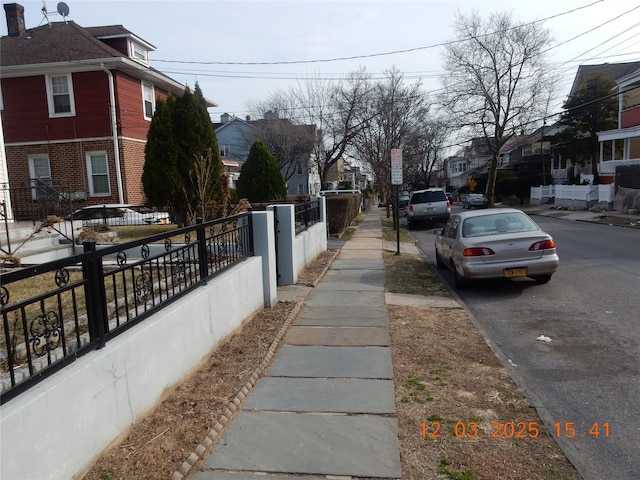 view of road with a residential view and sidewalks