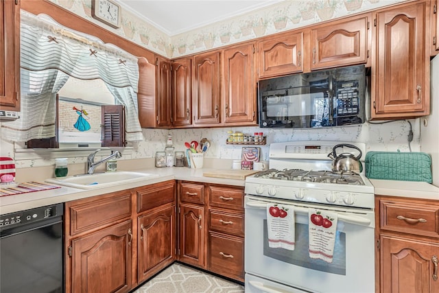 kitchen featuring ornamental molding, a sink, black appliances, light countertops, and brown cabinets