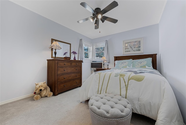 carpeted bedroom with baseboards and a ceiling fan