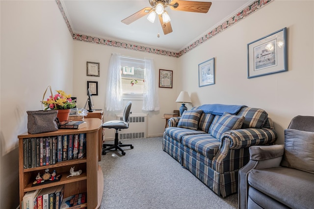 home office featuring radiator, baseboards, ceiling fan, ornamental molding, and carpet flooring