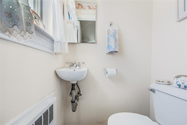 bathroom featuring toilet and radiator heating unit