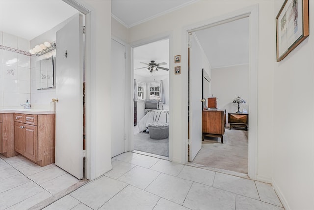 ensuite bathroom featuring connected bathroom, crown molding, tile patterned flooring, ceiling fan, and vanity