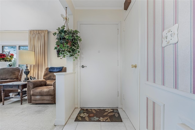 entrance foyer with light tile patterned floors and crown molding