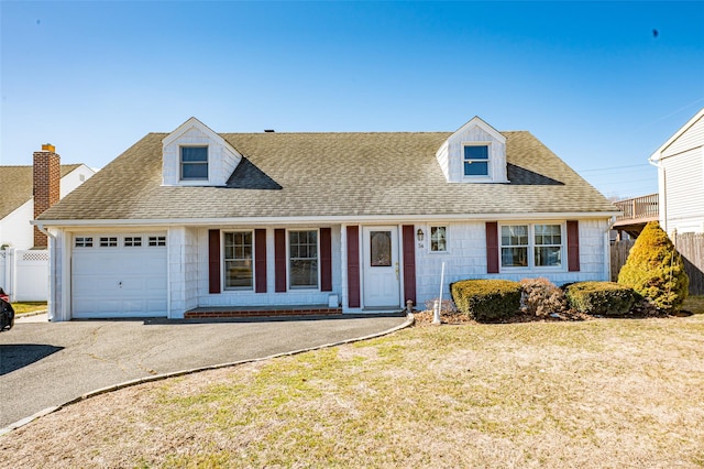 view of front of home with aphalt driveway, a shingled roof, fence, an attached garage, and a front yard