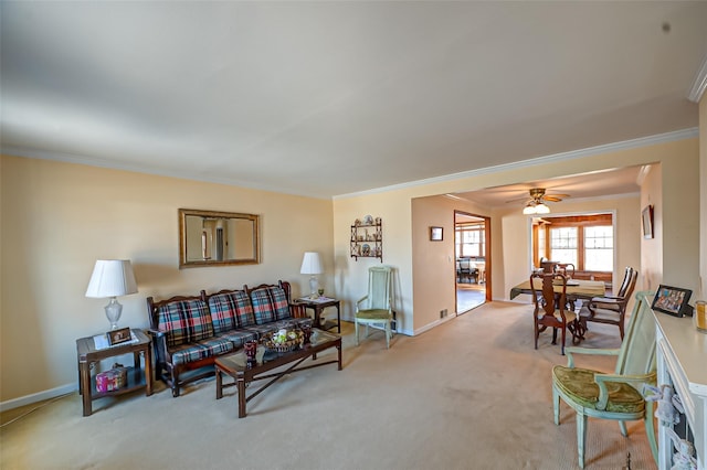 living area featuring a ceiling fan, carpet, baseboards, and ornamental molding