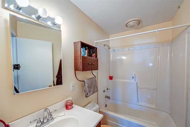 bathroom with visible vents, shower / washtub combination, vanity, and toilet