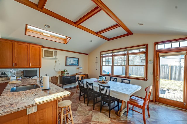 dining room featuring lofted ceiling and a wall unit AC