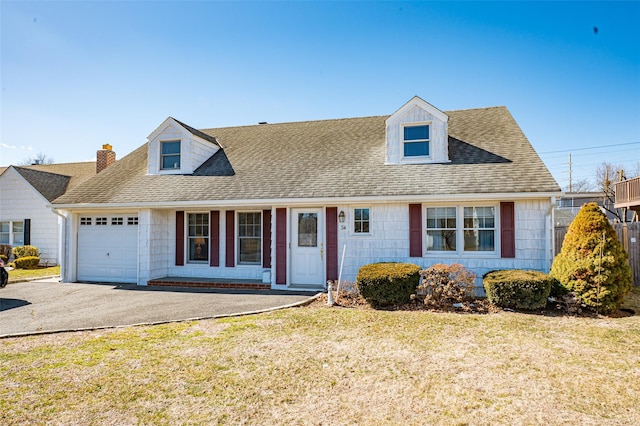 new england style home with a garage, driveway, a front lawn, and roof with shingles