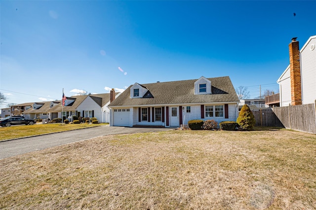 cape cod home featuring aphalt driveway, fence, a residential view, an attached garage, and a front yard