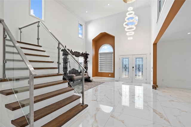 entrance foyer with stairs, french doors, marble finish floor, and baseboards