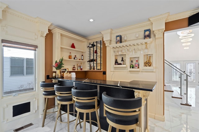 bar with visible vents, wet bar, and stairs