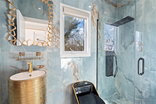 full bathroom with tile walls and a stall shower