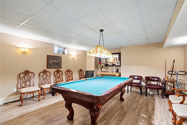 game room with a drop ceiling, a baseboard heating unit, wood finished floors, and billiards