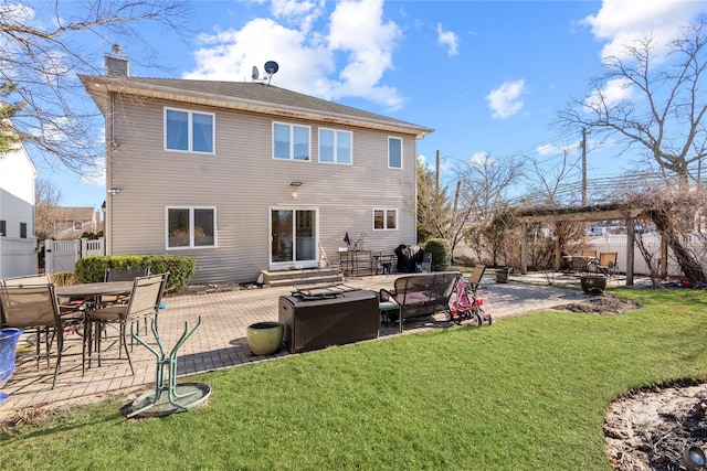 rear view of house featuring a yard, a patio, a chimney, and entry steps