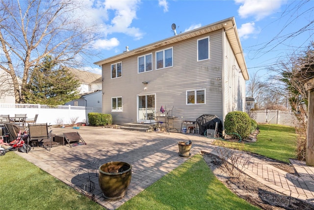 back of house with a patio, a fire pit, a fenced backyard, and a lawn