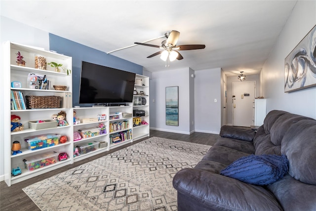 living area featuring baseboards, wood finished floors, and a ceiling fan