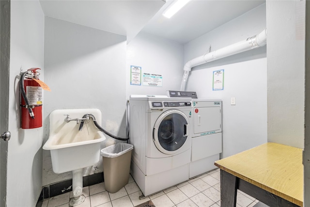 common laundry area featuring light tile patterned floors and separate washer and dryer