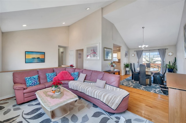 living room featuring an inviting chandelier, recessed lighting, wood finished floors, and high vaulted ceiling