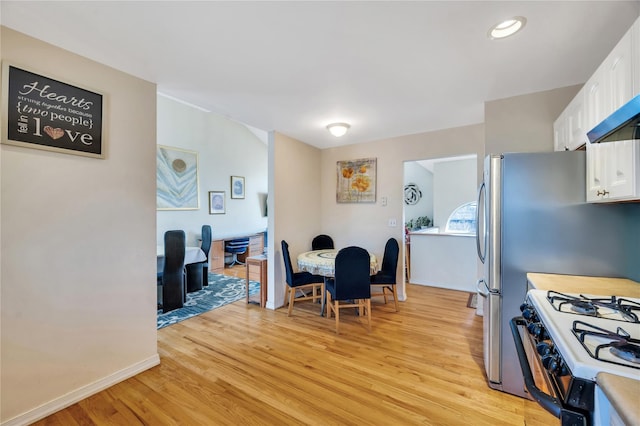 dining room with baseboards and light wood-style floors