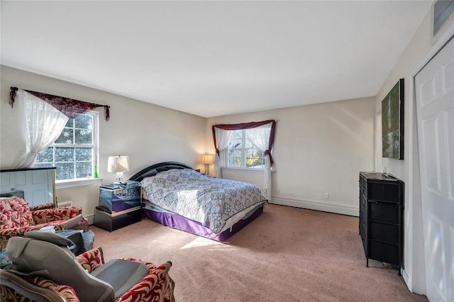 bedroom featuring baseboard heating, baseboards, and carpet floors