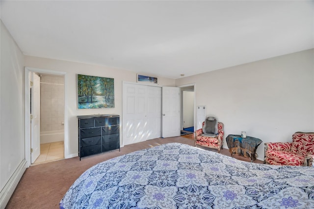 bedroom with carpet flooring, a closet, baseboard heating, and connected bathroom