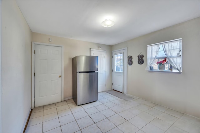 kitchen featuring light tile patterned flooring and freestanding refrigerator