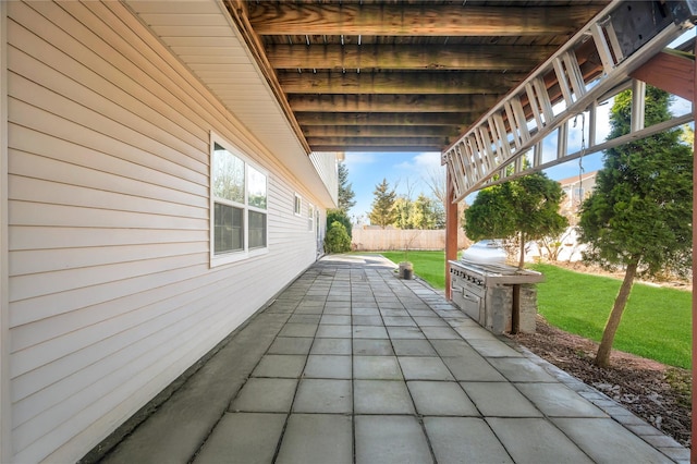 view of patio / terrace featuring fence