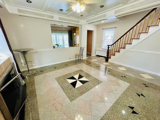 entrance foyer featuring a wealth of natural light, radiator, baseboards, and coffered ceiling