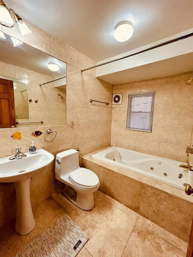 full bathroom featuring toilet, a combined bath / shower with jetted tub, a sink, tasteful backsplash, and tile walls