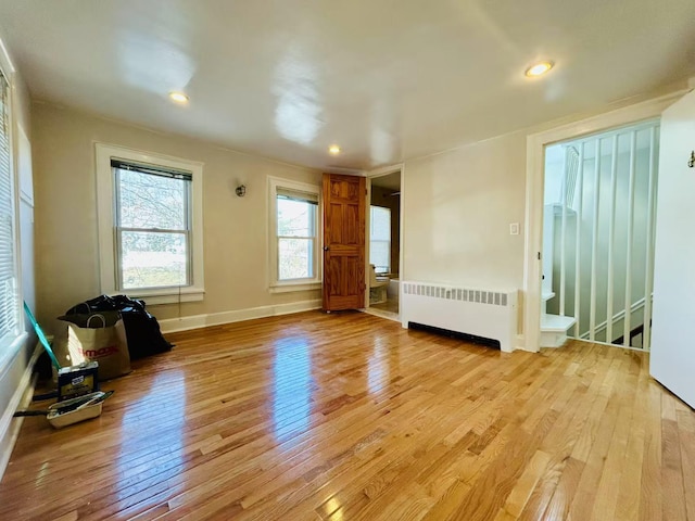 interior space featuring recessed lighting, light wood-type flooring, baseboards, and radiator