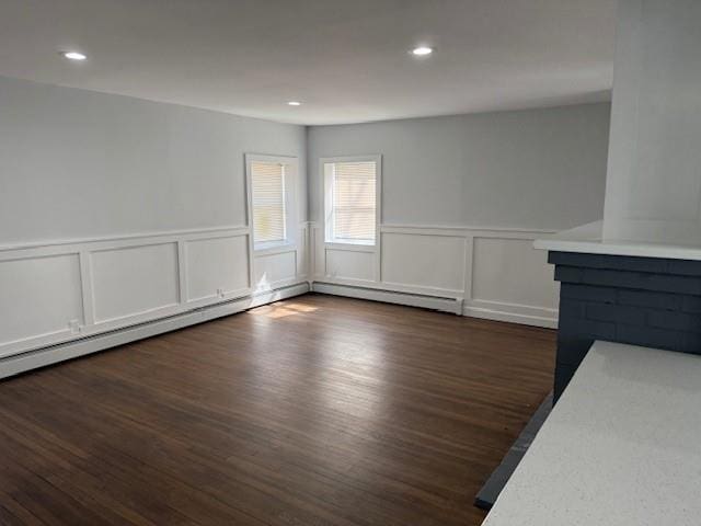 interior space with dark wood finished floors, recessed lighting, and wainscoting