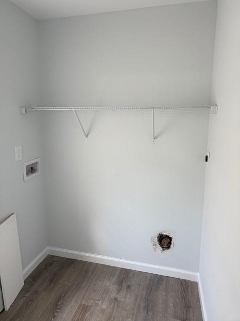 laundry area with baseboards, washer hookup, dark wood-style flooring, and laundry area