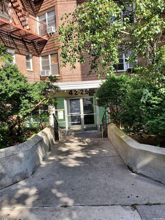 view of exterior entry featuring cooling unit, french doors, and brick siding