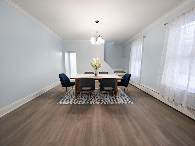 dining room with dark wood finished floors, crown molding, and baseboards