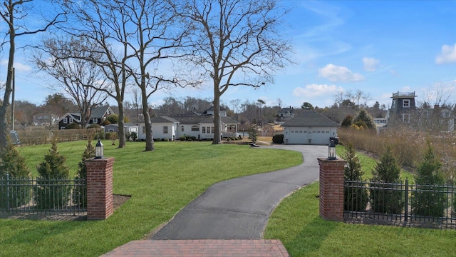 view of front of home with a front lawn, fence, a residential view, a garage, and driveway